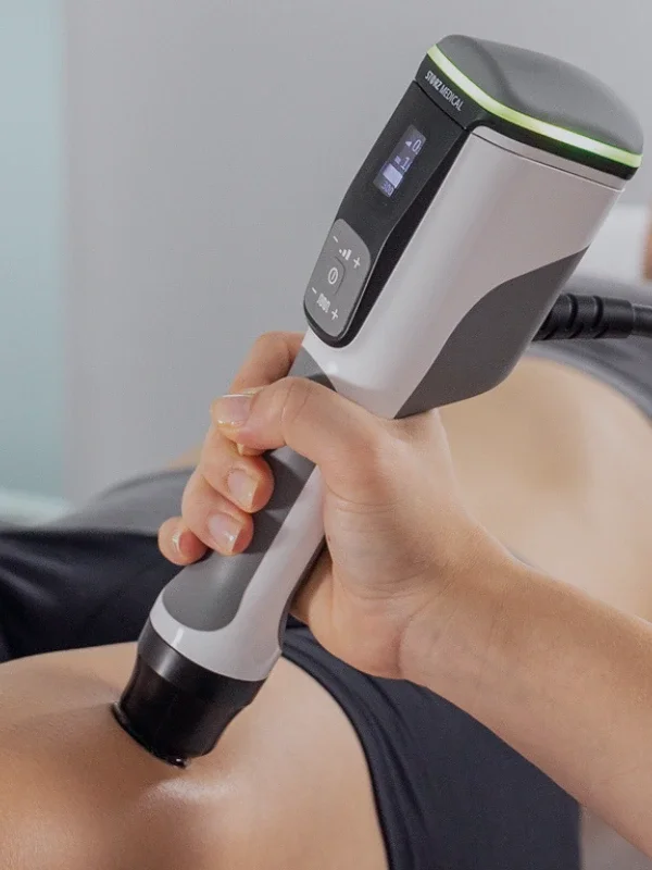 A focal shockwave applicator in a clinician's hand